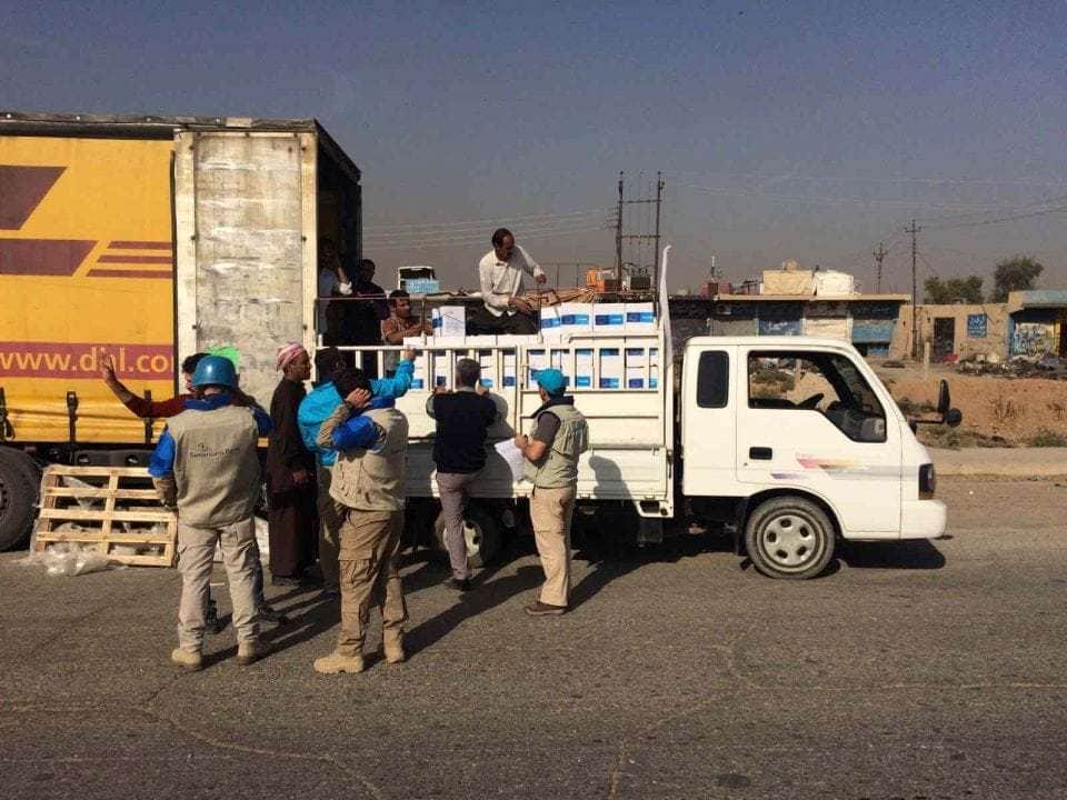 Workers load emergency supplies for 15,000 children onto a truck as part of a UNICEF-led humanitarian convoy into Mosul city. Up to 1.5 million people remain trapped inside the city, including 600,000 children. UNICEF Iraq/2016/Niles (CNW Group/UNICEF Canada)
